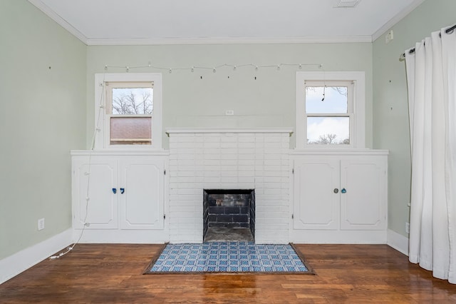 unfurnished living room featuring dark wood-style flooring, a fireplace, crown molding, and baseboards