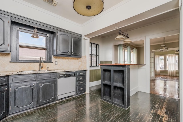 kitchen with hanging light fixtures, crown molding, visible vents, and dishwasher