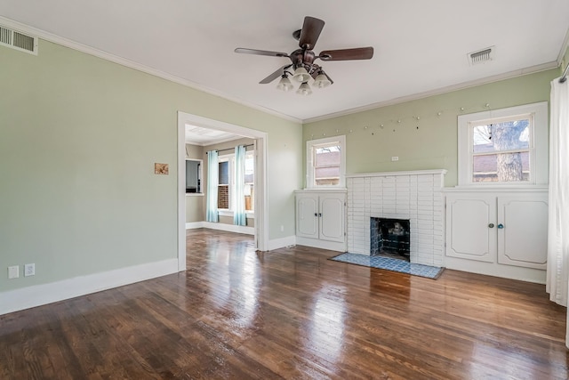 unfurnished living room with ornamental molding, dark wood-style flooring, visible vents, and a fireplace