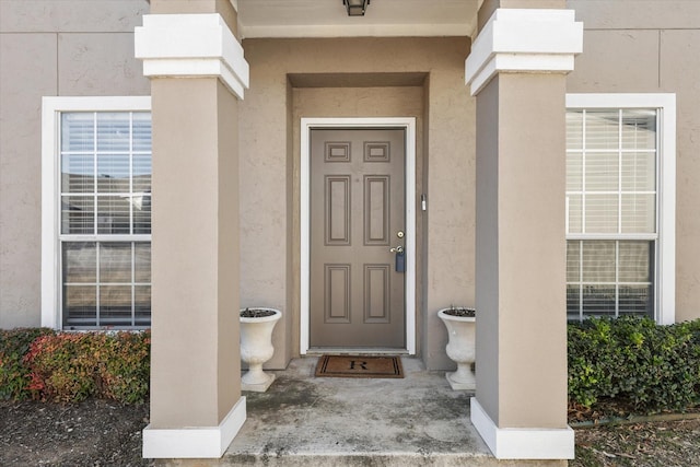 doorway to property with stucco siding