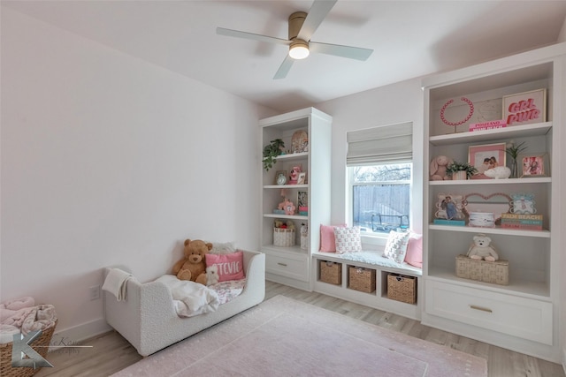 game room featuring light wood finished floors, baseboards, and a ceiling fan