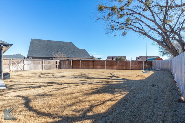 view of yard with a fenced backyard