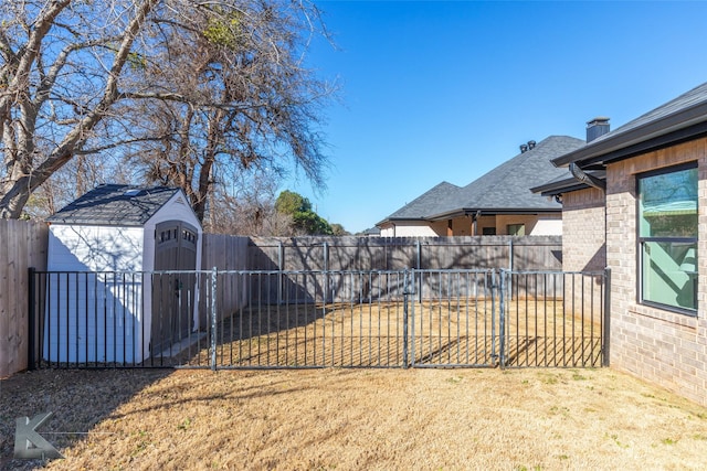 view of yard featuring a shed, a fenced backyard, and an outdoor structure