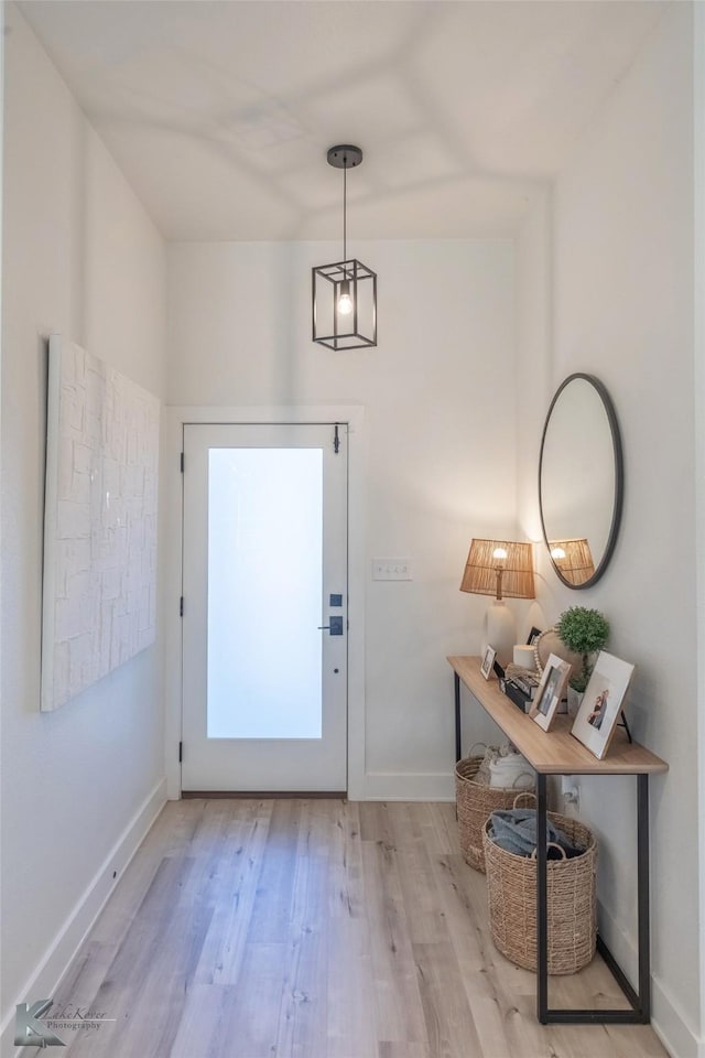 entryway featuring baseboards and light wood-style floors