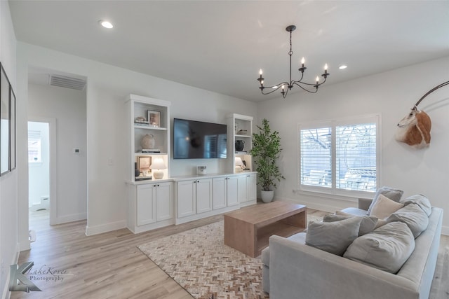 living area featuring an inviting chandelier, light wood-style flooring, visible vents, and recessed lighting