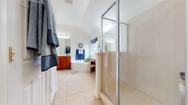 full bathroom featuring lofted ceiling, tile patterned floors, a freestanding bath, vanity, and a shower stall