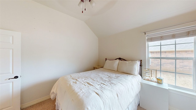 bedroom featuring a ceiling fan, lofted ceiling, and baseboards