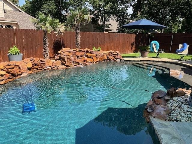 view of swimming pool featuring a fenced backyard