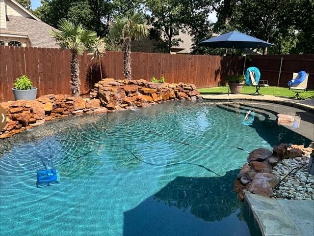 view of swimming pool featuring a fenced backyard