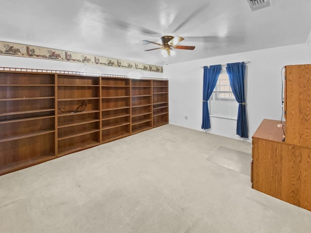 interior space featuring visible vents, a ceiling fan, and carpet flooring