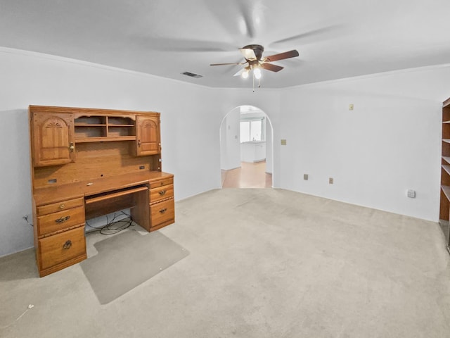 office featuring light carpet, visible vents, arched walkways, and a ceiling fan