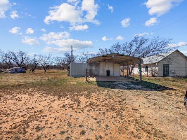 view of outbuilding with a carport and driveway