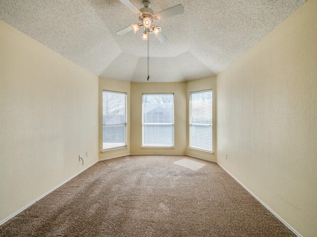 unfurnished room with baseboards, a textured ceiling, ceiling fan, and carpet floors