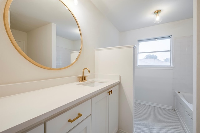 bathroom with vanity, baseboards, and tile patterned floors