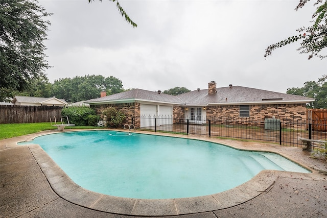 view of swimming pool with a fenced in pool and fence