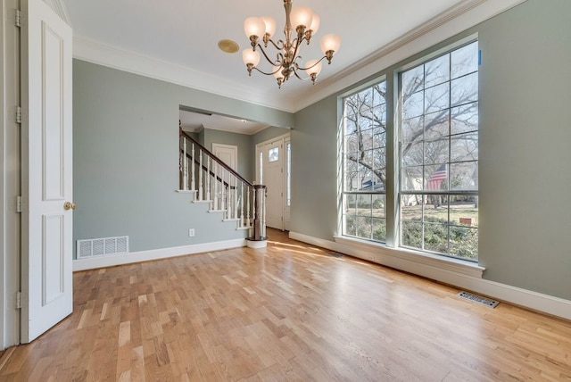 foyer entrance with stairs, visible vents, and baseboards