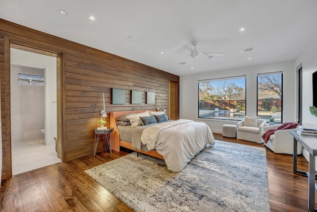 bedroom with recessed lighting, visible vents, wooden walls, and wood finished floors