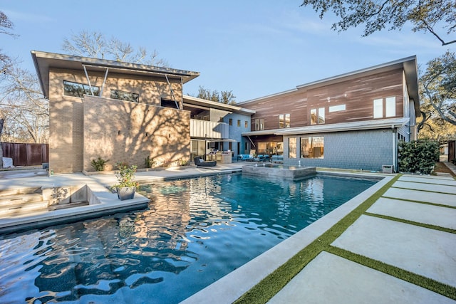 view of swimming pool with a patio, an outdoor fire pit, and a fenced in pool