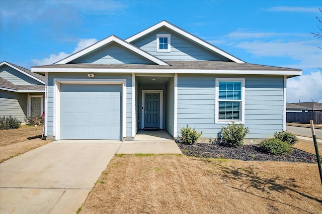 single story home with driveway and an attached garage