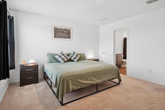 bedroom with carpet, baseboards, and ensuite bathroom