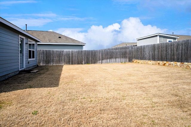 view of yard with a fenced backyard