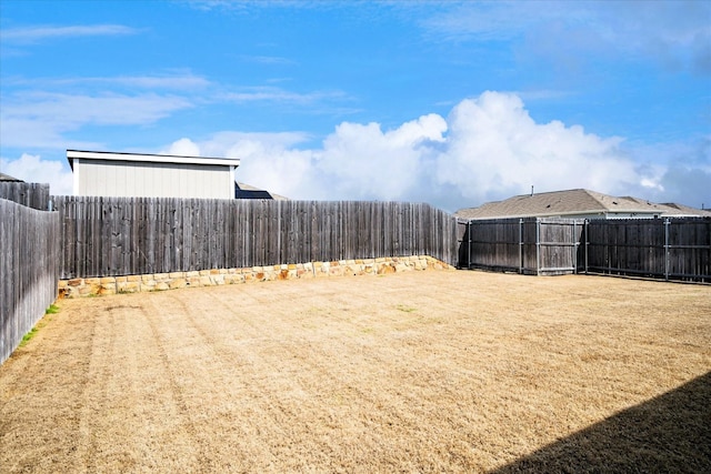 view of yard with a fenced backyard