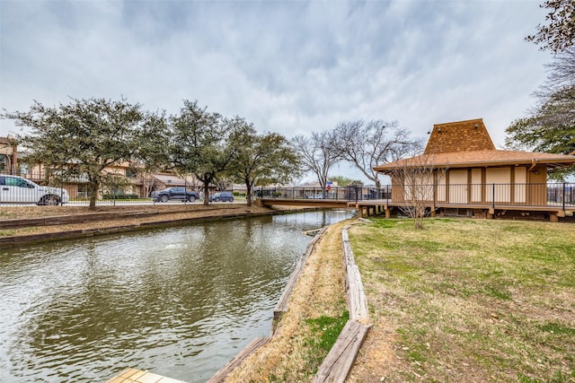 dock area featuring a yard and a water view