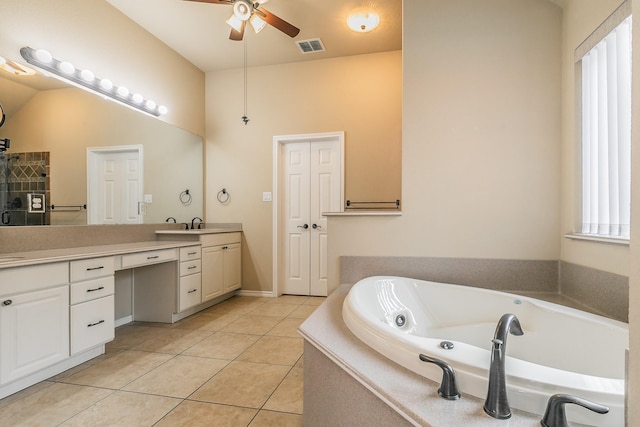 bathroom with visible vents, ceiling fan, a bath, tile patterned floors, and vanity