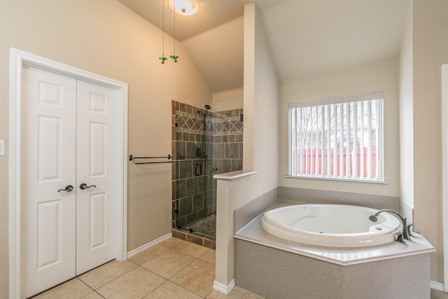 full bath with tile patterned flooring, a shower stall, a garden tub, and vaulted ceiling