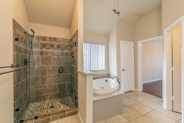 bathroom with tile patterned floors, a tub with jets, a shower stall, and vaulted ceiling