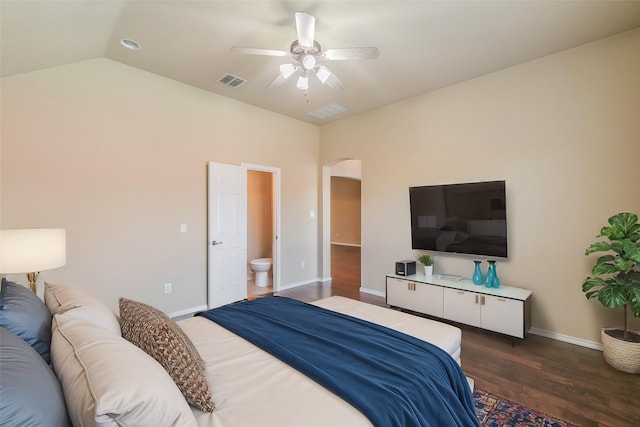 bedroom featuring visible vents, baseboards, vaulted ceiling, dark wood-style floors, and arched walkways