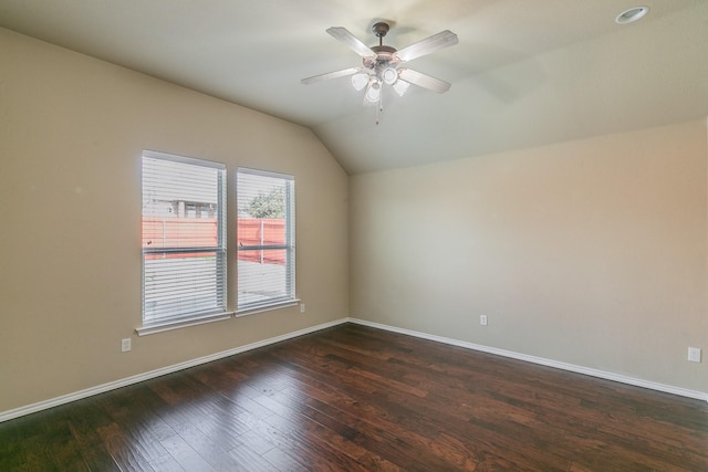 unfurnished room featuring dark wood-style floors, baseboards, a ceiling fan, and lofted ceiling