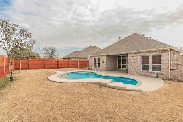 view of swimming pool with a fenced backyard, a fenced in pool, a yard, and a patio