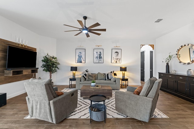 living room featuring ceiling fan, baseboards, visible vents, and wood tiled floor