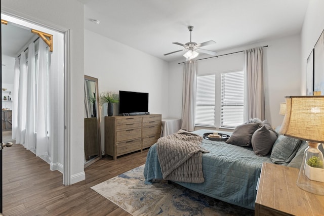 bedroom with wood finished floors and a ceiling fan