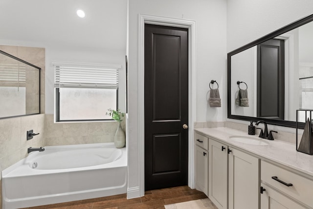 full bathroom featuring vanity and a bath