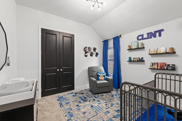 carpeted bedroom with vaulted ceiling, a nursery area, a sink, and baseboards