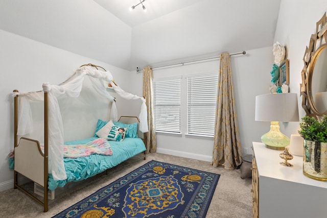 bedroom with carpet, baseboards, and vaulted ceiling