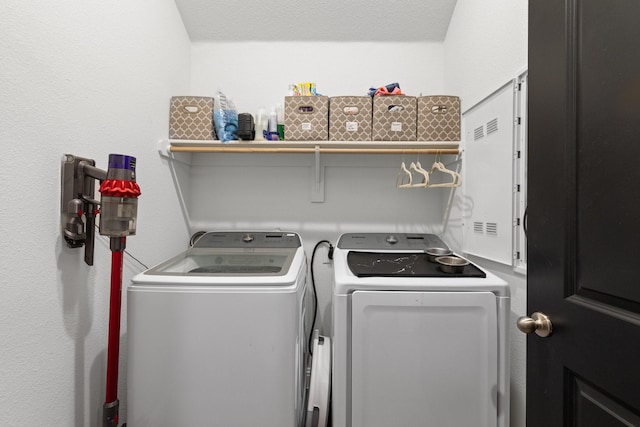 clothes washing area with laundry area and washer and clothes dryer