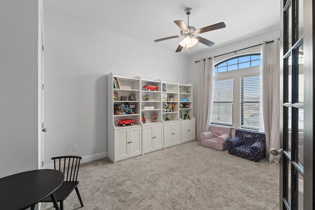 recreation room with ceiling fan, carpet floors, and baseboards