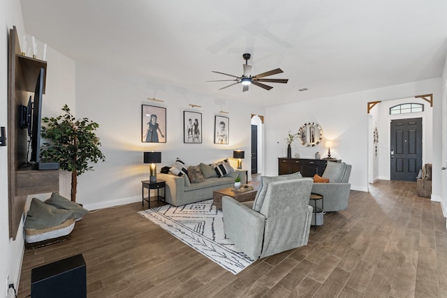 living room with ceiling fan, wood finished floors, visible vents, and baseboards