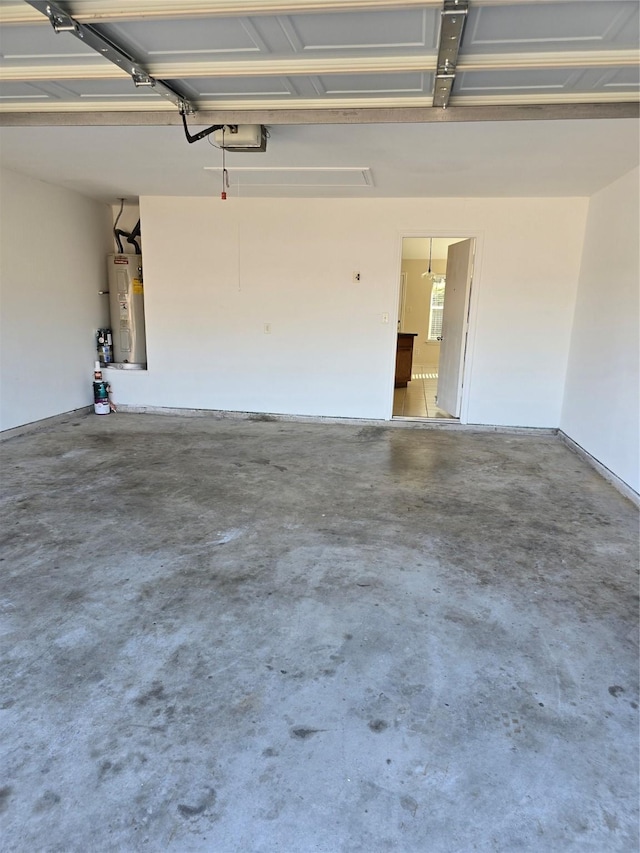 garage with a garage door opener and electric water heater