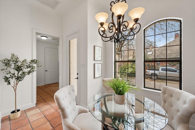 dining area with crown molding, light tile patterned floors, visible vents, an inviting chandelier, and baseboards