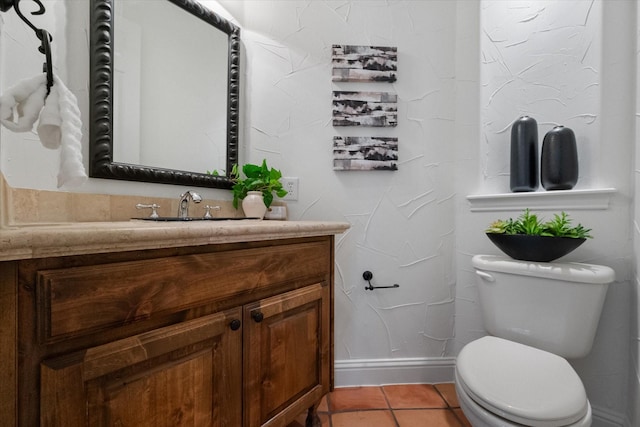 half bath featuring tile patterned flooring, vanity, and toilet