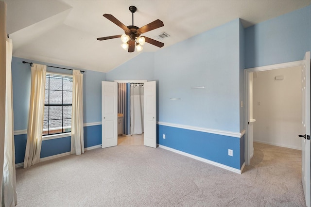 unfurnished bedroom with carpet floors, baseboards, visible vents, and lofted ceiling