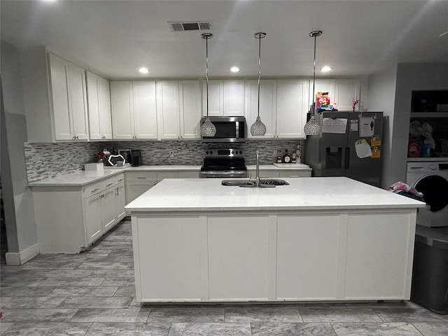 kitchen with a sink, white cabinets, stainless steel appliances, and light countertops