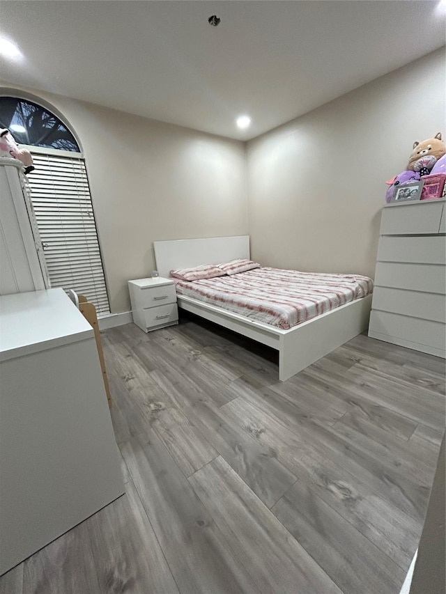 bedroom with baseboards and light wood-style floors