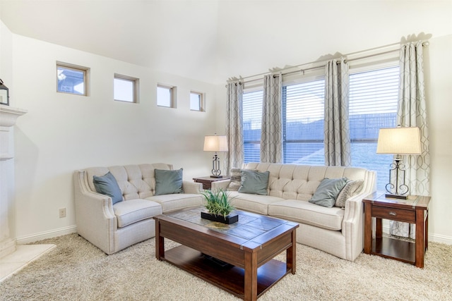 living room featuring carpet and baseboards