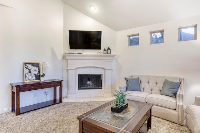 carpeted living room with lofted ceiling and a tile fireplace