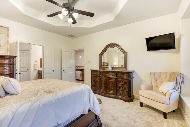 1005 Brendan Dr, Little Elm, TX 75068 - bedroom featuring a tray ceiling, light colored carpet, connected bathroom, and baseboards